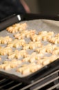 Ready backed cookies on backing paper in a tray