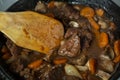 Ready of Beef Burgeoning beef dish in a frying pan. meat, carrots and onions and mushrooms. Appetizing sauce. Slow food Royalty Free Stock Photo