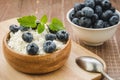 ready breakfast with cottage cheese and blueberry/ready breakfast with cottage cheese and blueberry on a wooden background.