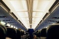 Ready for a change of scene. Rearview shot of unidentifiable passengers seated in an airplane cabin. Royalty Free Stock Photo