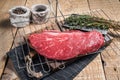 Ready for cooking raw top sirloin beef meat steak on a grill, or rump steak. wooden background. Top view Royalty Free Stock Photo