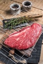 Ready for cooking raw top sirloin beef meat steak on a grill, or rump steak. wooden background. Top view Royalty Free Stock Photo