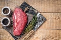 Ready for cooking raw top sirloin beef meat steak on a grill, or rump steak. wooden background. Top view. Copy space Royalty Free Stock Photo