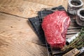 Ready for cooking raw top sirloin beef meat steak on a grill, or rump steak. wooden background. Top view. Copy space Royalty Free Stock Photo