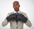 Ready for the corporate competition. Portrait of a handsome african businessman wearing boxing gloves. Royalty Free Stock Photo