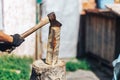 Ready for cutting timber. Close-up of axe cutting log while other logs laying in the background Royalty Free Stock Photo