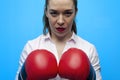 Ready for a fight. Determined business woman wearing boxing gloves.