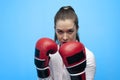 Ready for a fight. Determined business woman wearing boxing gloves. Royalty Free Stock Photo