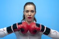 Ready for a fight. Determined business woman wearing boxing gloves. Royalty Free Stock Photo