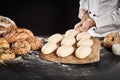 Ready formed loaves of bread on a wooden paddle