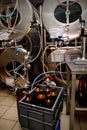 Ready fresh beer in plastic bottles near the brewing tanks