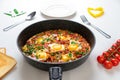 Ready Fried eggs with vegetables and bread, top view. Recipe and cooking process for Shakshuka and Menemen. Tasty breakfast Royalty Free Stock Photo