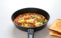 Ready Fried eggs with vegetables and bread, top view. Recipe and cooking process for Shakshuka and Menemen. Tasty breakfast Royalty Free Stock Photo