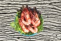 Grilled large fresh prawns served with megetables on blue plate