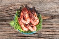 Grilled large fresh prawns served with megetables on blue plate