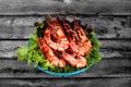 Grilled large fresh prawns served with megetables on blue plate