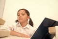 She is ready with her home task. Girl child read book while sit table white background. Schoolgirl studying and reading