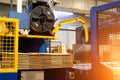 Ready-made cardboard boxes are moved in stacks along an automated packaging line. The strapping machine packs the stacks