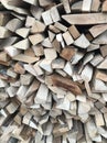 A background made of wood. Cut and chopped logs with ready-made pieces of wood f ready-made firewood in front of the winter house Royalty Free Stock Photo