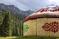 Almost ready-made Kyrgyz traditional yurt house on the background of mountains covered with coniferous forest