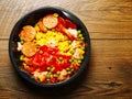 Ready made Spanish paella in a black plastic dish for microwave on a wooden table. Premium quality meal for take away or on the go Royalty Free Stock Photo