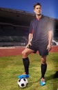 Ready for the next game. a young footballer standing on a field with a ball under his foot.