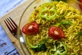 Ready noodles with vegetables and herbs on a wooden board.