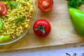 Ready noodles with vegetables and herbs on a wooden board.