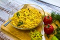 Ready noodles with vegetables and herbs on a wooden board.