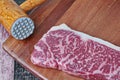 Ready raw fresh steak as wagyu beef  MS5+ with meat hammer on butcher served  for cooking Royalty Free Stock Photo