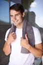Ready and refreshed for a new day. a cheerful man standing with a towel around his neck.
