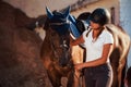 Ready for the ride. Horsewoman in uniform and black protective helmet with her horse Royalty Free Stock Photo