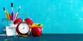 Ready for school, Back to school concept. Alarm clock with pencils and school accessory on blue chalkboard background Royalty Free Stock Photo