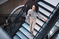 Ready, set, go get that success. a confident young businesswoman walking up the stairs in a modern workplace. Royalty Free Stock Photo