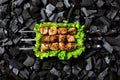 Ready shish kebab. Grilled meat on skewers in an aluminum disposable container with salad. Royalty Free Stock Photo