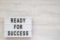 `Ready for success` words on a lightbox on a white wooden surface, top view. Overhead, from above, flat lay. Copy space Royalty Free Stock Photo