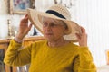 ready for summer - senior woman in hat at home medium closeup living room seniority concept