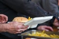 Ready take away meal plate with freshly cooked burger and french fries on outdoors kitchen at street music festival