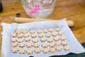 Ready to bake: cookie dough in star shapes on baking sheet, with