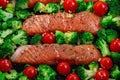 Ready to bake raw salmon fillet with broccoli and tomato, horizontal, top view, closeup Royalty Free Stock Photo