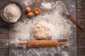 Ready to be baked dough. Top view of board, rolling pin and flour and dough