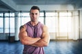 Ready to build some more muscle. Portrait of a muscular young man listening to music at the gym. Royalty Free Stock Photo