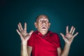 Close up portrait of crazy scared and shocked man isolated on dark background