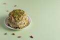 Ready to eat halva and nuts on green background