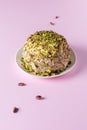 Ready to eat halva and nuts on pink background