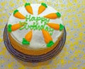 ready to eat Happy Birthday carrot cake with white frosting and carrots Royalty Free Stock Photo