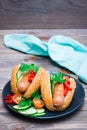 Ready-to-eat hot dogs from fried sausages, sesame buns and fresh vegetables on a plate Royalty Free Stock Photo