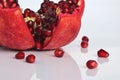 Ready to eat red ripe juicy pomegranate fruit with seeds, healthy eating concept on a white background Royalty Free Stock Photo