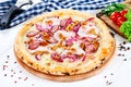 Close up view on pizza on white wooden background with ingridients. Italian cuisine. Royalty Free Stock Photo