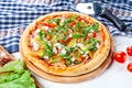 Close up view on pizza on white wooden background with ingridients. Italian cuisine. Royalty Free Stock Photo